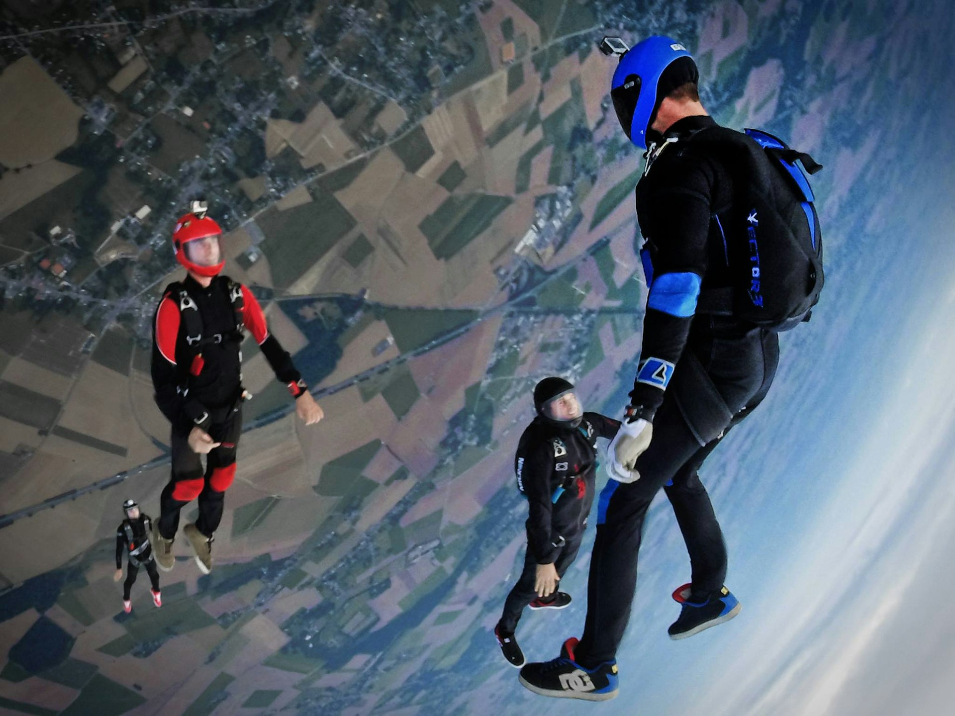 aerial photography of three people skydiving